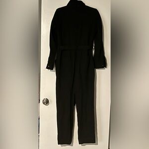 Skies are blue black denim jumpsuit with snap buttonned front